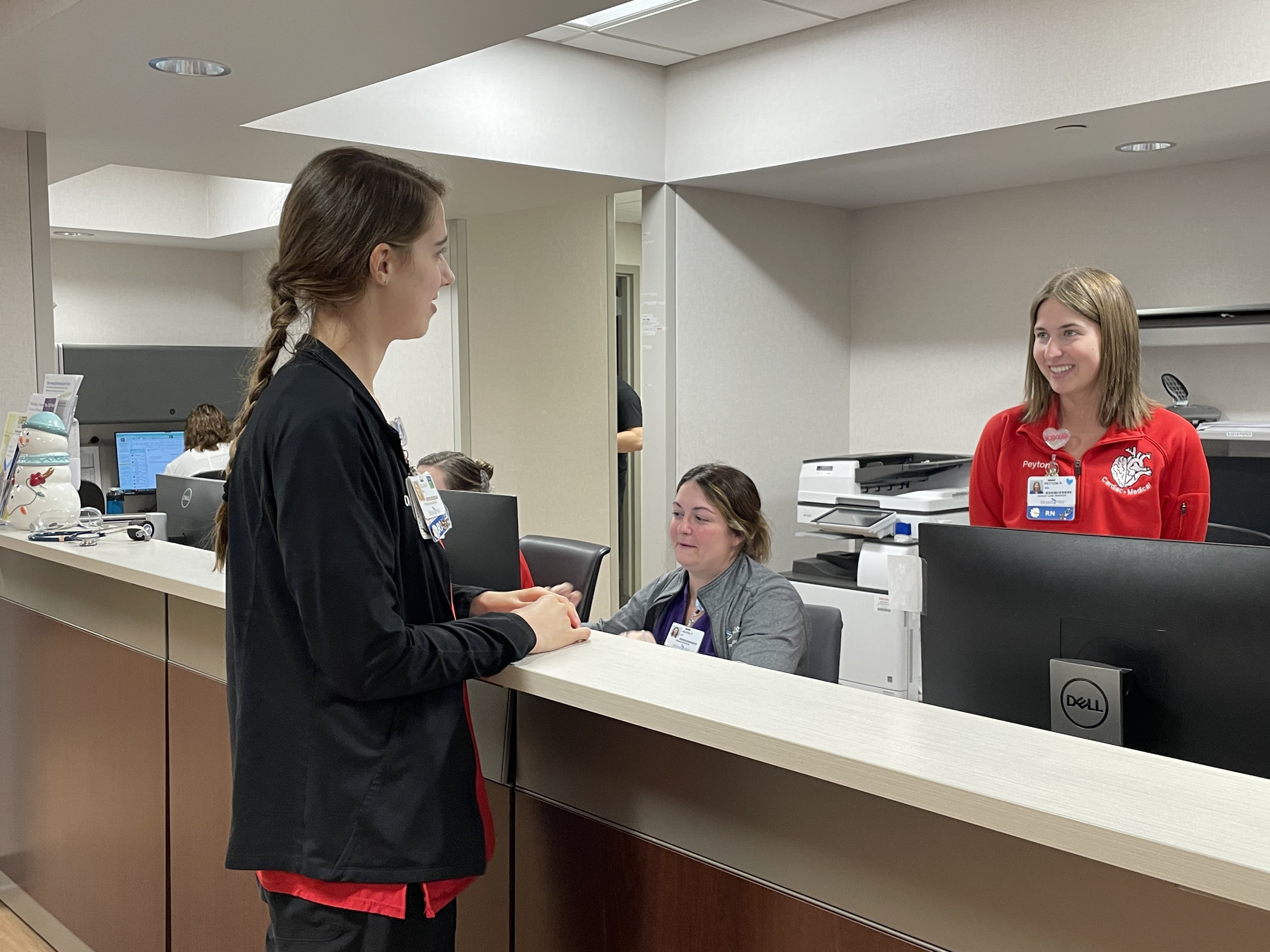 Olivia Oerman at desk with team