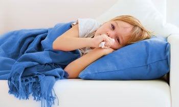 sick child on couch that needs urgent care